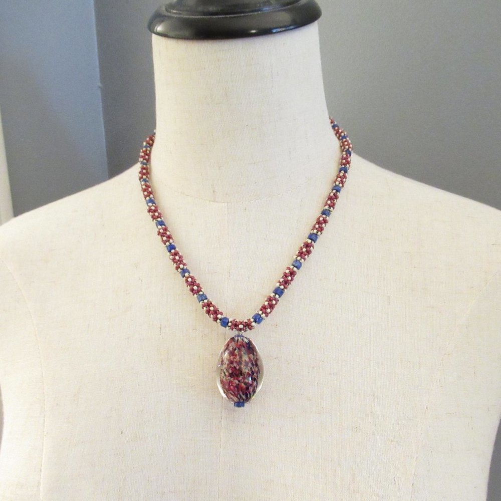 Blown glass pendant necklace with handweaving and Lapis